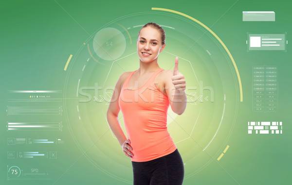 happy sportive young woman showing thumbs up Stock photo © dolgachov