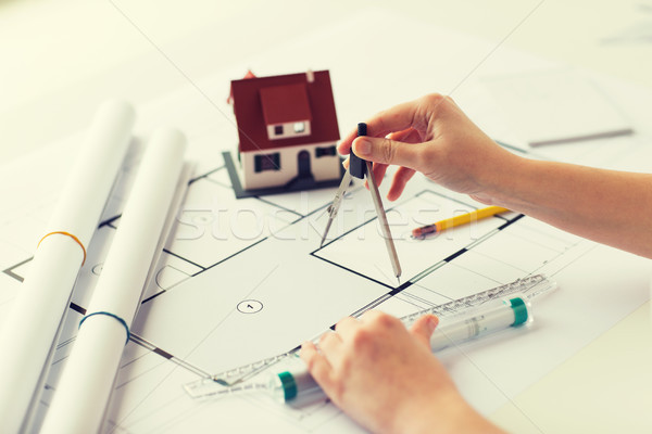 close up of hands with compass measuring blueprint Stock photo © dolgachov