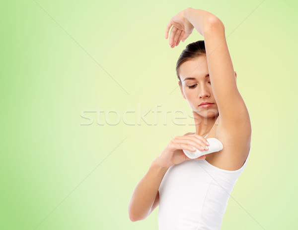 Stock photo: woman with antiperspirant deodorant over white