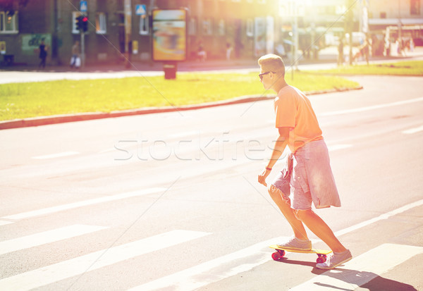 teenage boy on skateboard crossing city crosswalk Stock photo © dolgachov