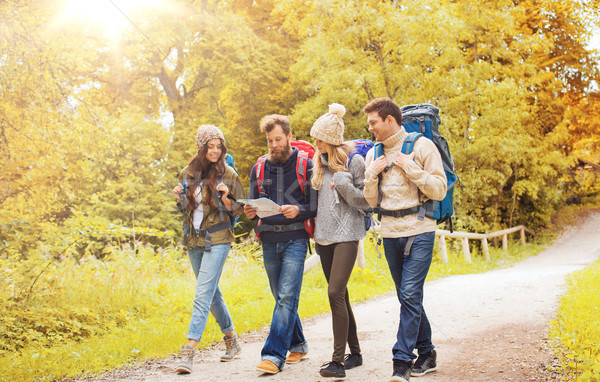 group of smiling friends with backpacks hiking Stock photo © dolgachov