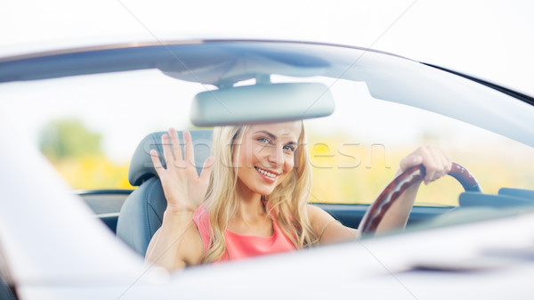 happy young woman driving convertible car Stock photo © dolgachov