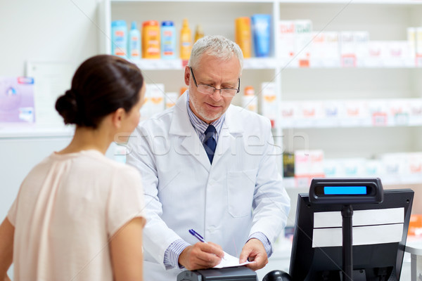 Stock photo: senior apothecary with prescription at pharmacy