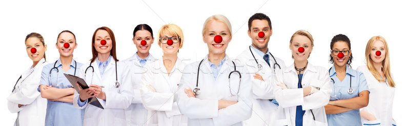group of smiling doctors at red nose day Stock photo © dolgachov