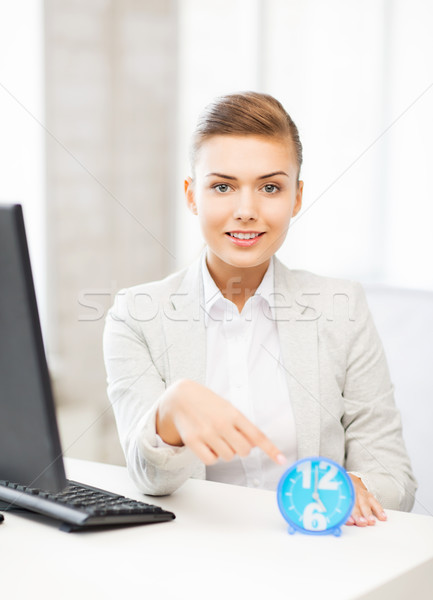 attractive businesswoman pointing at clock Stock photo © dolgachov