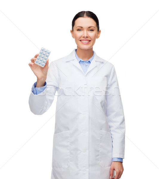 Stock photo: smiling female doctor with pills