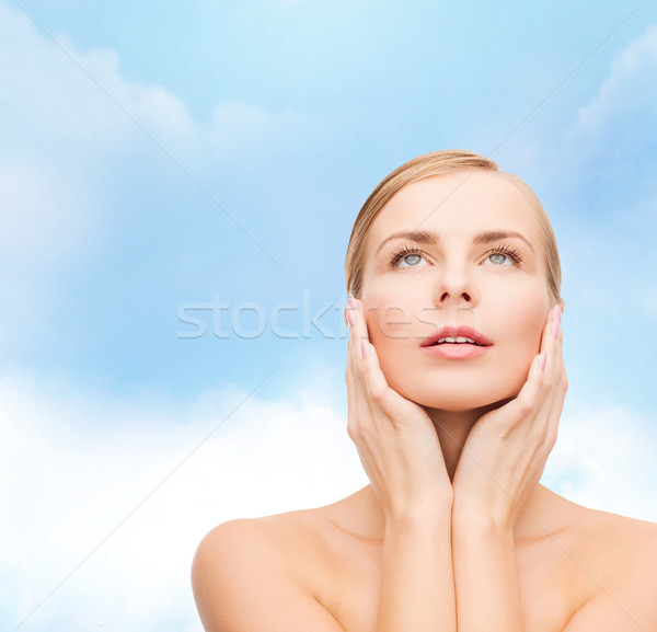 beautiful woman touching her face and looking up Stock photo © dolgachov