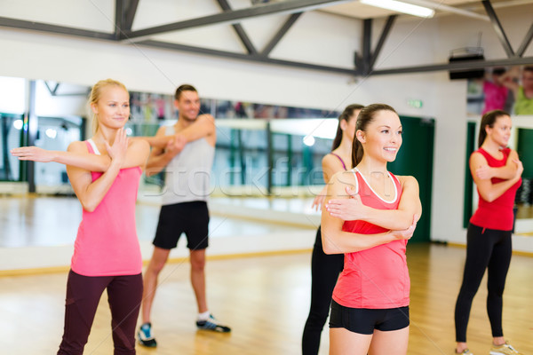 group of smiling people stretching in the gym Stock photo © dolgachov