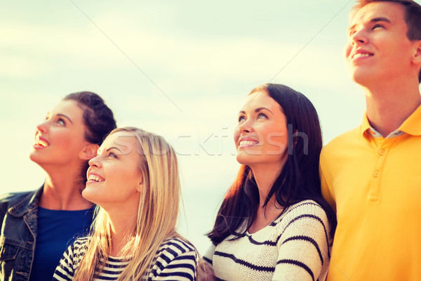 group of friends looking up on the beach Stock photo © dolgachov