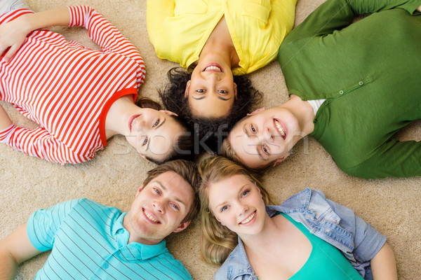 Csoport mosolyog emberek fekszik padló oktatás Stock fotó © dolgachov