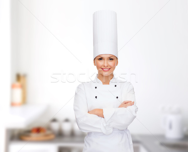 smiling female chef with crossed arms Stock photo © dolgachov