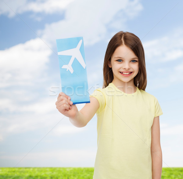 smiling little girl with airplane ticket Stock photo © dolgachov