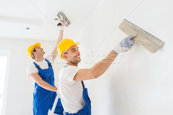 group of builders with tools indoors Stock photo © dolgachov