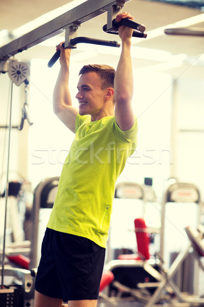 smiling man exercising in gym Stock photo © dolgachov