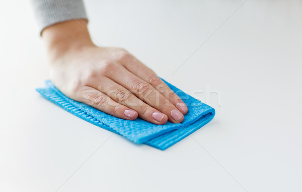 close up of hand cleaning table surface with cloth Stock photo © dolgachov
