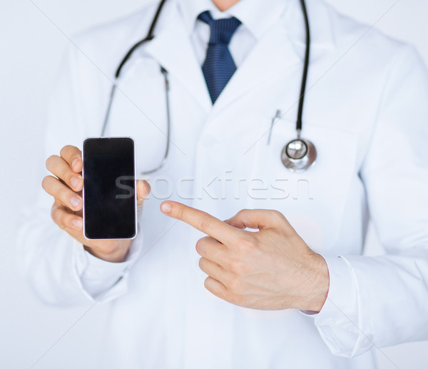 doctor pointing at smartphone Stock photo © dolgachov