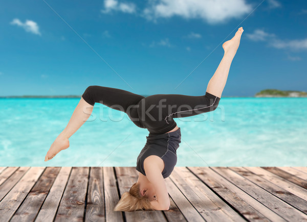 happy young woman doing yoga exercise Stock photo © dolgachov