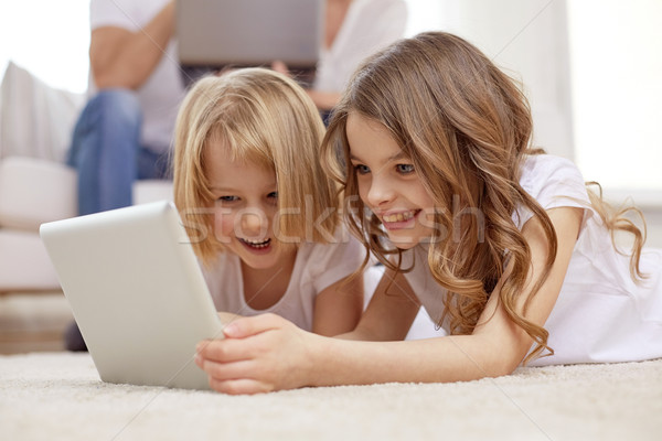 happy little girls with tablet pc computer at home Stock photo © dolgachov