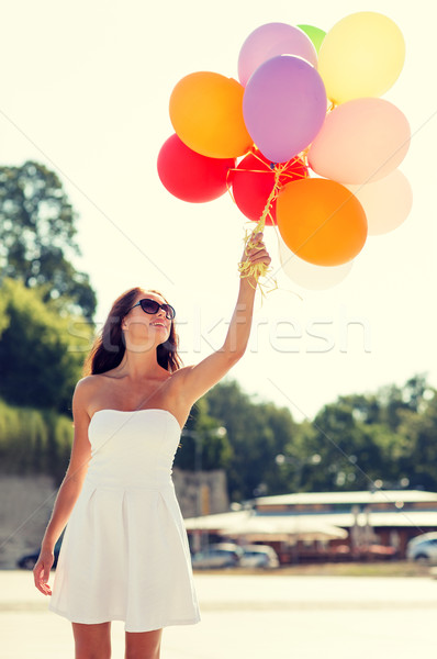 smiling young woman in sunglasses with balloons Stock photo © dolgachov