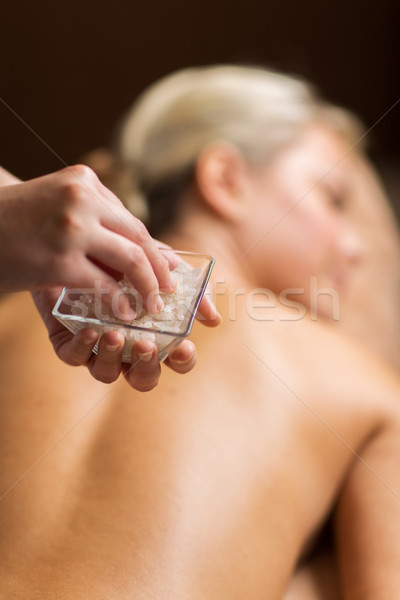 close up of woman having salt massage in spa Stock photo © dolgachov