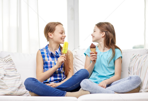 happy little girls eating ice-cream at home Stock photo © dolgachov