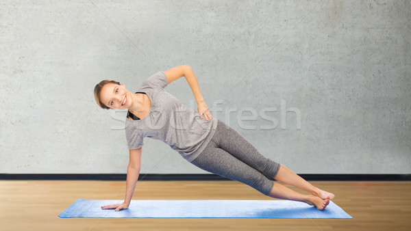 Woman Making Yoga In Side Plank Pose On Mat Stock Photo C Syda