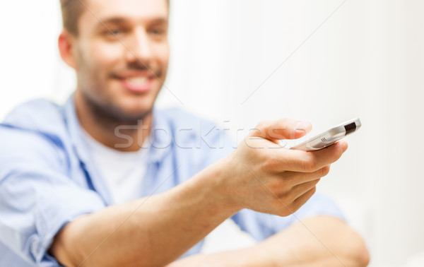 close up of man with tv remote control at home Stock photo © dolgachov