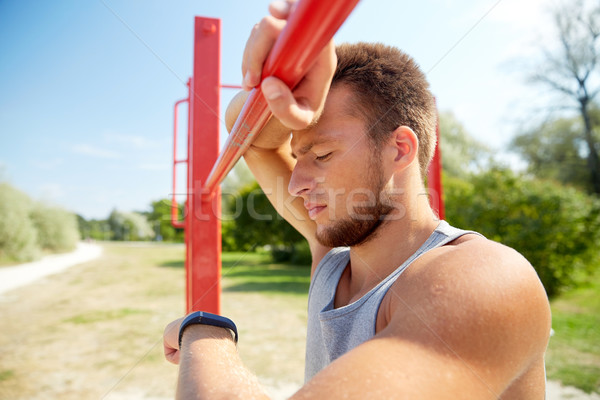 man with heart-rate watch exercising outdoors Stock photo © dolgachov