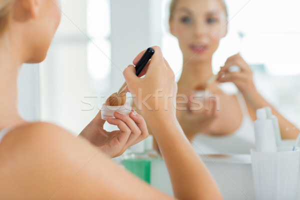 woman with makeup brush and powder at bathroom Stock photo © dolgachov