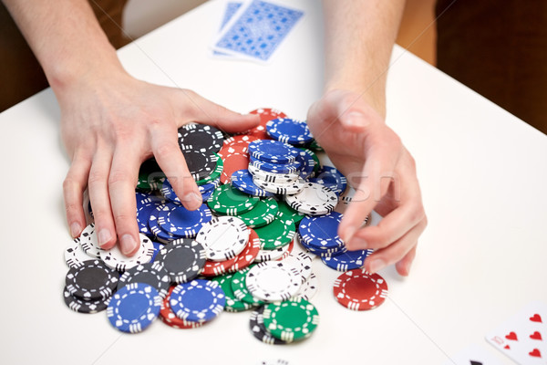 hands with casino chips making bet or taking win Stock photo © dolgachov