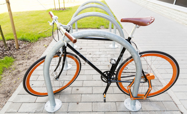 close up of bicycle locked at street parking Stock photo © dolgachov