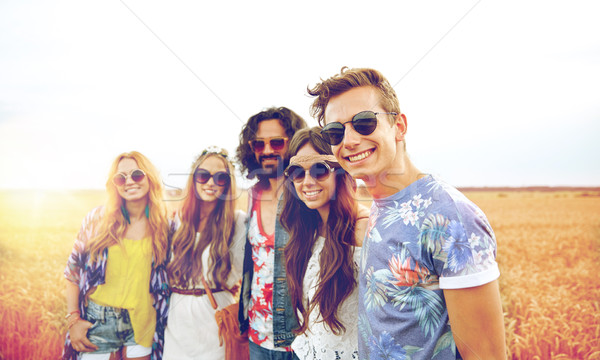 smiling young hippie friends on cereal field Stock photo © dolgachov