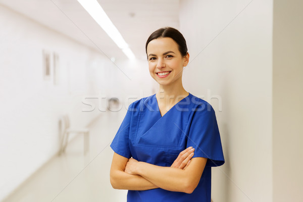 happy doctor or nurse at hospital corridor Stock photo © dolgachov
