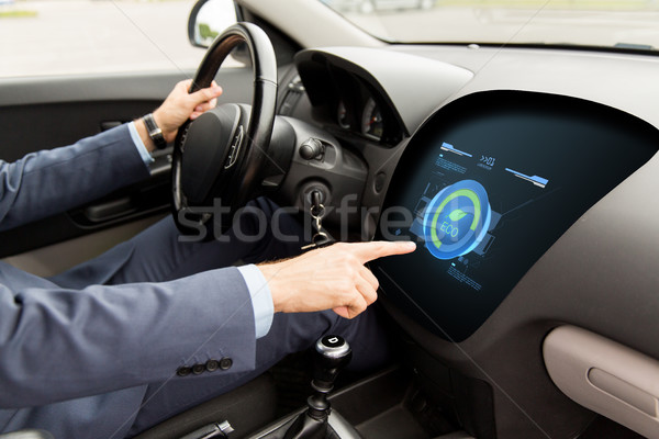 Stock photo: man driving car with eco mode on board computer