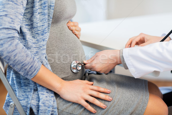 Lekarza stetoskop kobieta w ciąży brzuch ciąży ginekologia Zdjęcia stock © dolgachov