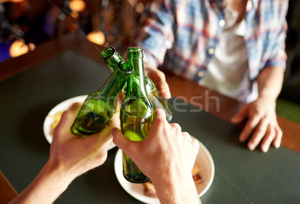 close up of friends drinking beer at bar or pub Stock photo © dolgachov