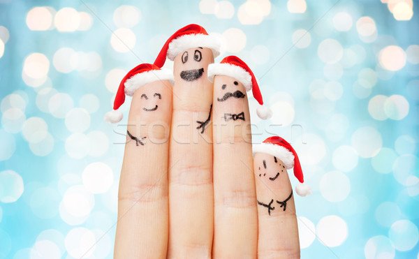 close up of hand with four fingers in santa hats Stock photo © dolgachov