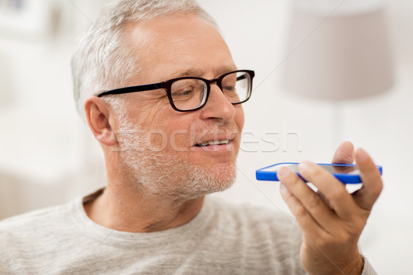 old man using voice command recorder on smartphone Stock photo © dolgachov