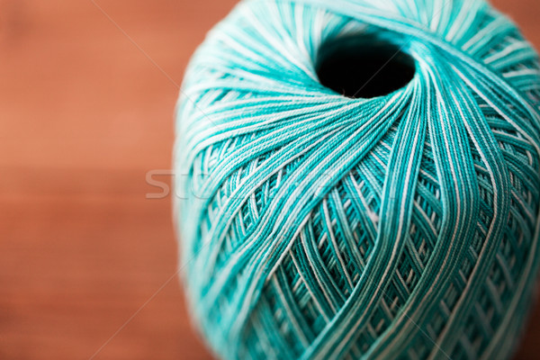 close up of turquoise knitting yarn ball on wood Stock photo © dolgachov