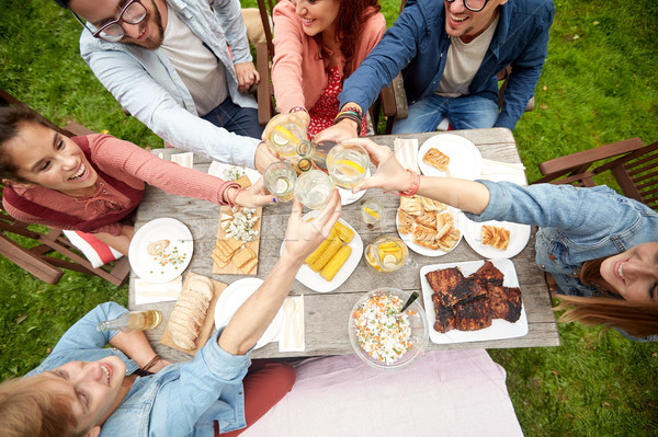 happy friends with drinks at summer garden party Stock photo © dolgachov