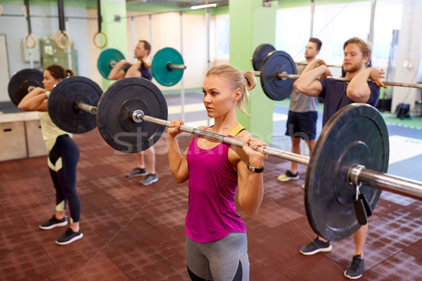 group of people training with barbells in gym Stock photo © dolgachov