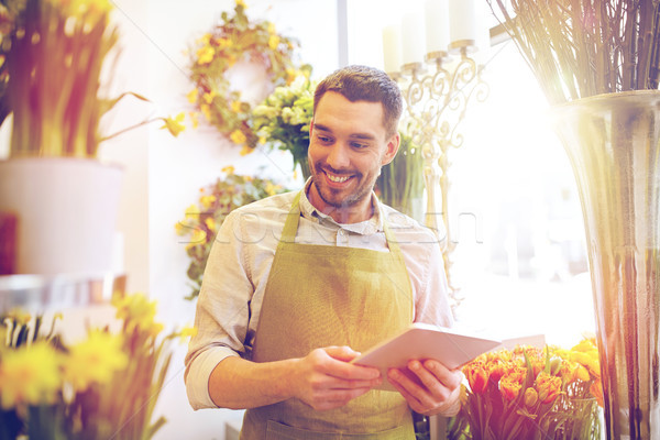 man with tablet pc computer at flower shop Stock photo © dolgachov