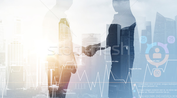 business people shaking hands over city background Stock photo © dolgachov