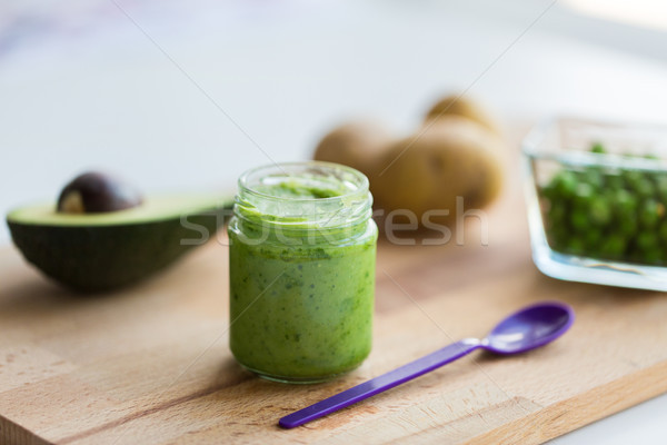 Stock photo: jar with puree or baby food on wooden board