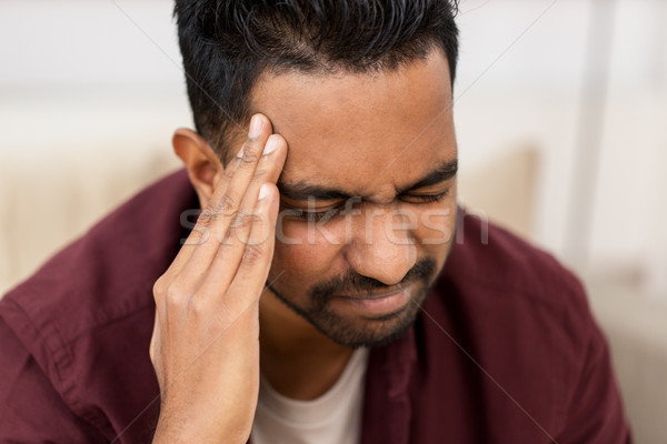 close up of man suffering from head ache at home Stock photo © dolgachov