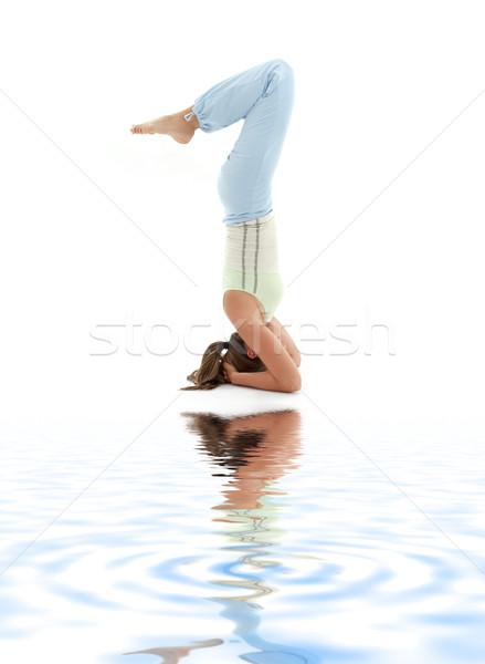 salamba sirsasana supported headstand on white sand #2 Stock photo © dolgachov