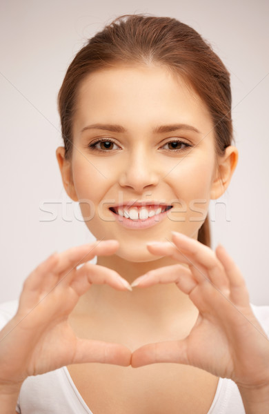 happy woman making heart gesture Stock photo © dolgachov