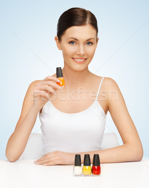 woman with nail polish bottles Stock photo © dolgachov