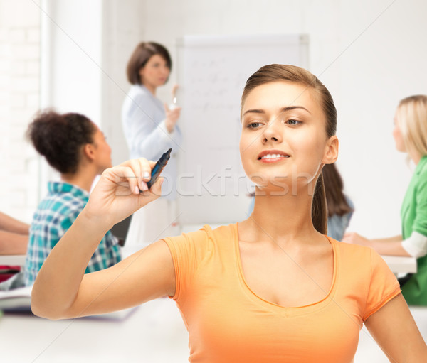 student writing something in the air with marker Stock photo © dolgachov