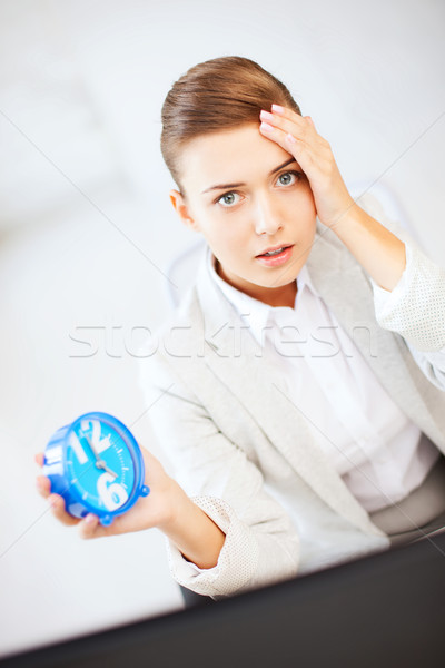 stressed businesswoman holding clock Stock photo © dolgachov